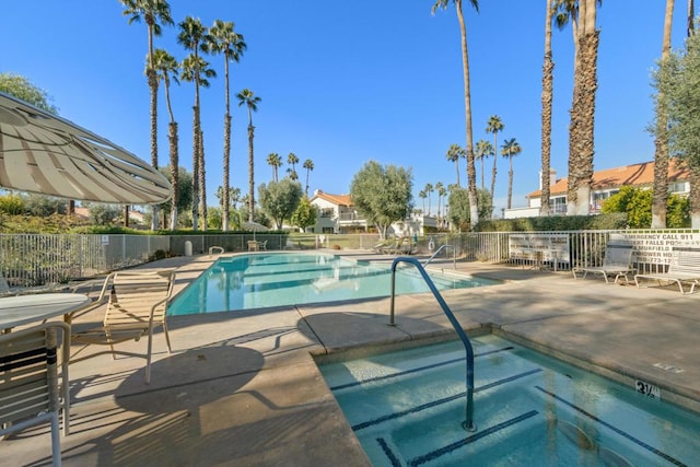 view of pool featuring a hot tub and a patio