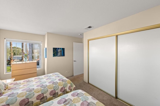 bedroom featuring light colored carpet and a closet