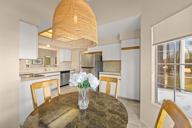 tiled dining room featuring sink