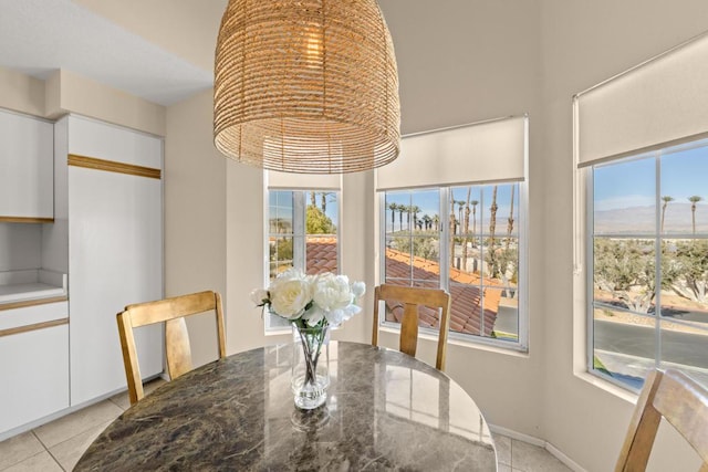 dining room with a wealth of natural light and light tile patterned flooring