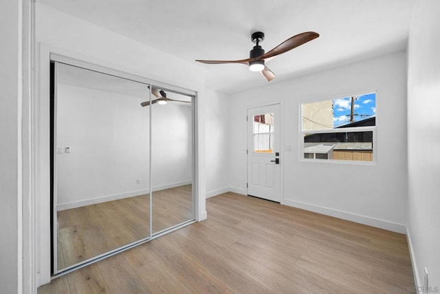 foyer with light hardwood / wood-style floors and ceiling fan