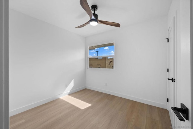 spare room with ceiling fan and light wood-type flooring