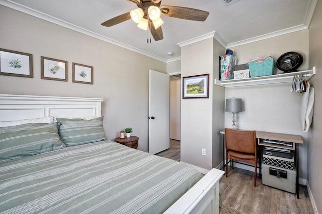 bedroom featuring ceiling fan, ornamental molding, and light hardwood / wood-style flooring