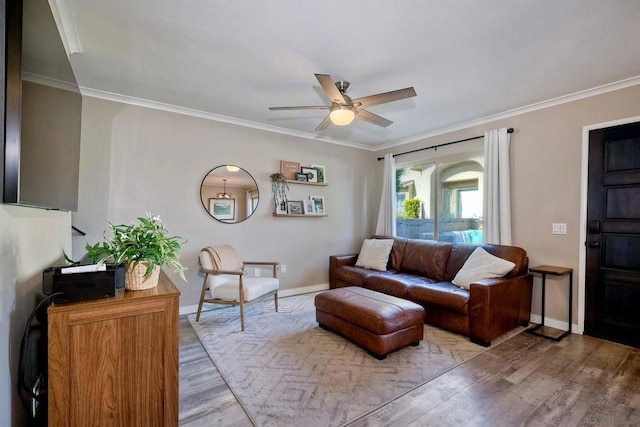 living room with ceiling fan, wood-type flooring, and ornamental molding