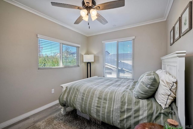 bedroom with ceiling fan, ornamental molding, hardwood / wood-style floors, and multiple windows