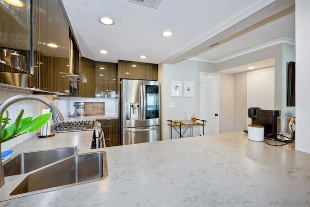 kitchen featuring stainless steel fridge, sink, and crown molding