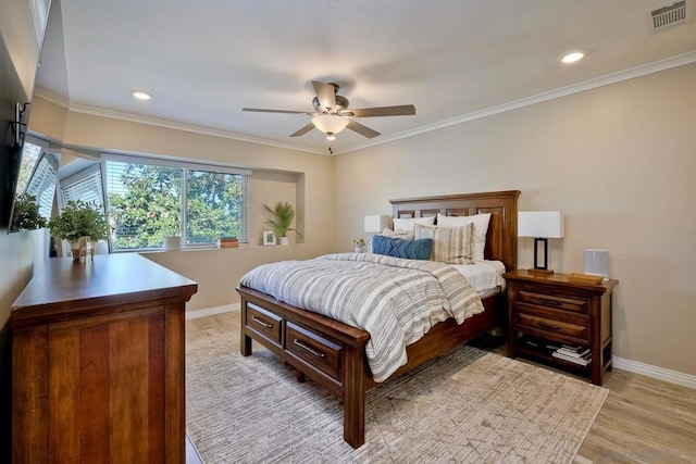 bedroom with ceiling fan, crown molding, and light hardwood / wood-style floors