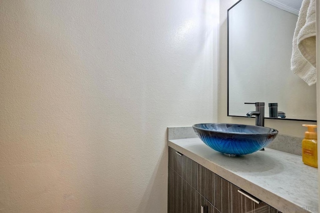 bathroom featuring vanity and ornamental molding