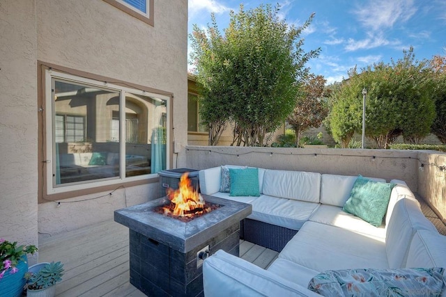 wooden deck featuring a fire pit