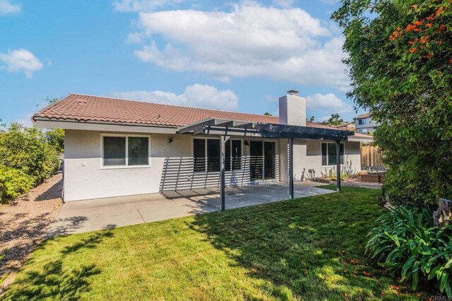 back of house featuring a pergola, a yard, and a patio