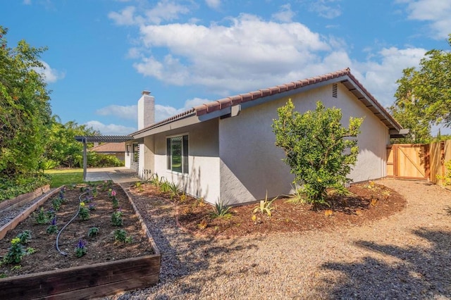 view of property exterior featuring a patio area and a pergola