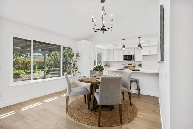 dining space with light wood-type flooring and an inviting chandelier