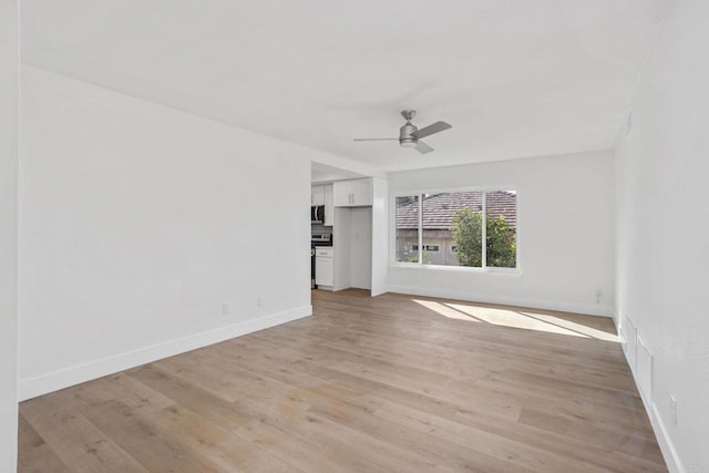 unfurnished living room featuring ceiling fan and light wood-type flooring