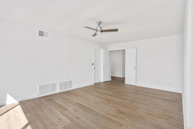 empty room with ceiling fan and light wood-type flooring