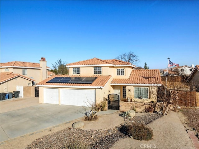 mediterranean / spanish-style house featuring a garage and solar panels