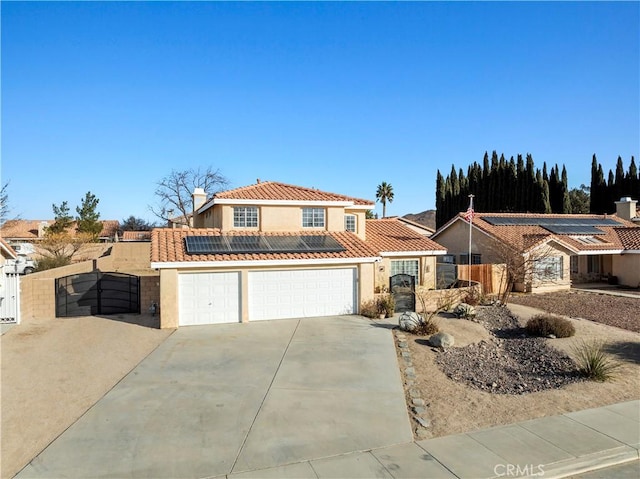 view of front of home featuring a garage and solar panels