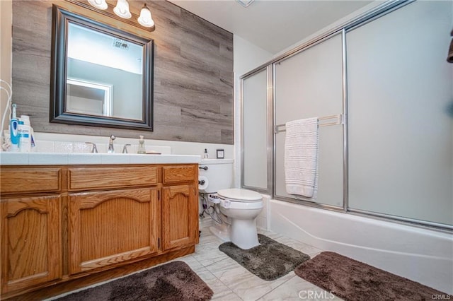 full bathroom featuring visible vents, bath / shower combo with glass door, vanity, and toilet