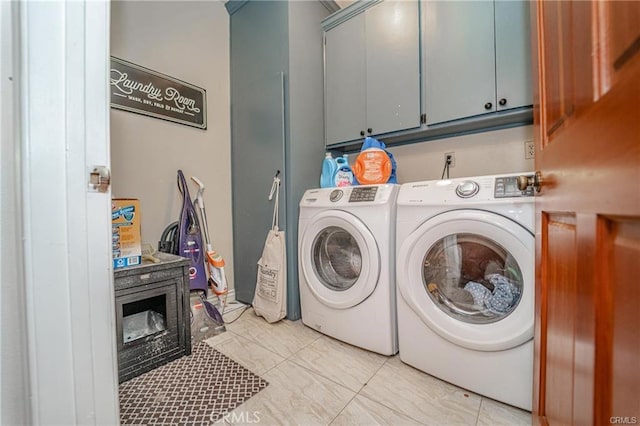 washroom featuring cabinet space and separate washer and dryer