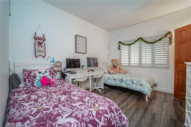 bedroom featuring baseboards and wood finished floors