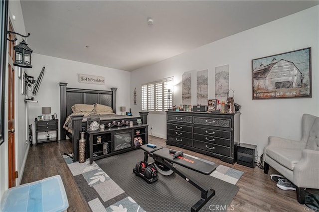 bedroom with baseboards and wood finished floors