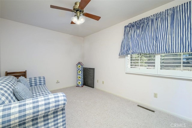 sitting room featuring carpet and ceiling fan