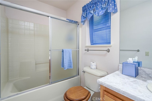 full bathroom featuring toilet, vanity, and shower / bath combination with glass door