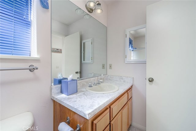 bathroom with toilet and vanity