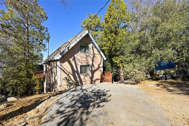 view of side of home featuring a wooden deck