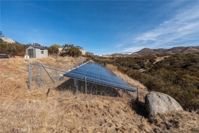 exterior space featuring a mountain view, a rural view, and solar panels