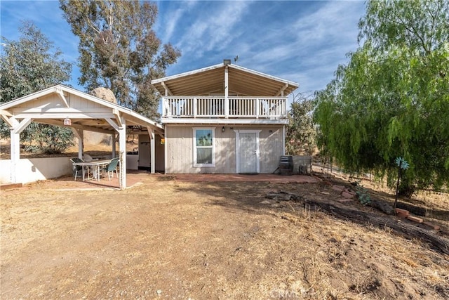 back of house with a balcony