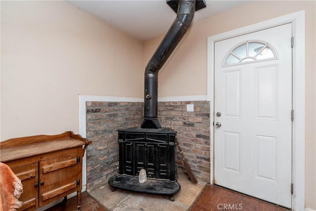 room details with a wood stove and wood-type flooring