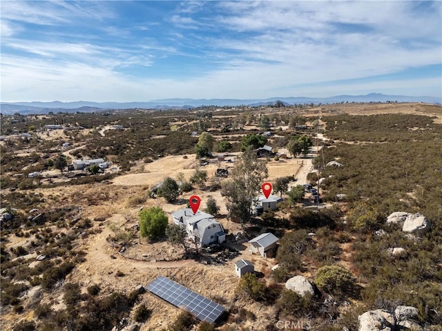 birds eye view of property featuring a mountain view