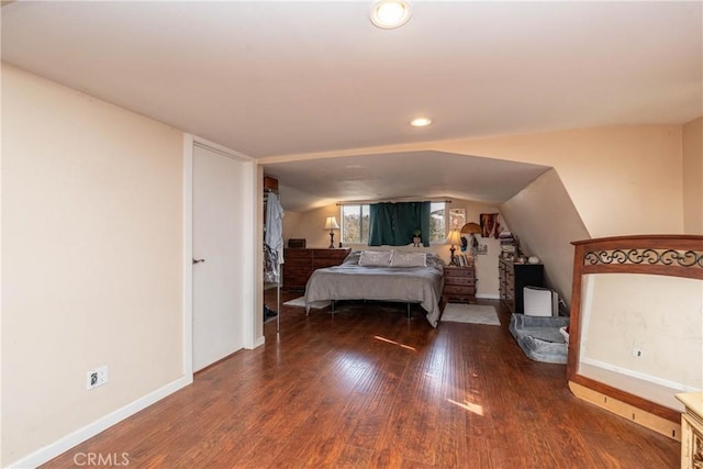 bedroom with vaulted ceiling and dark hardwood / wood-style floors