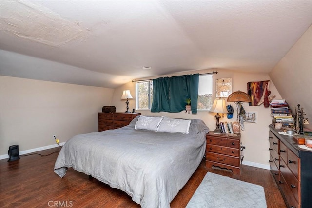 bedroom with dark hardwood / wood-style flooring and vaulted ceiling