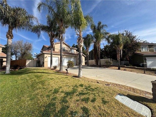 view of front of house with a garage and a front lawn