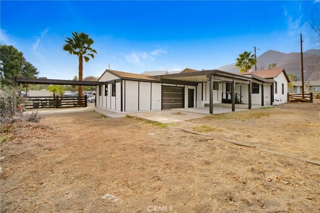 view of front of home with a garage and a mountain view