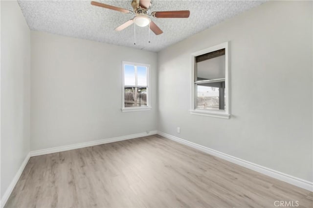 unfurnished room featuring a textured ceiling, ceiling fan, and light hardwood / wood-style floors