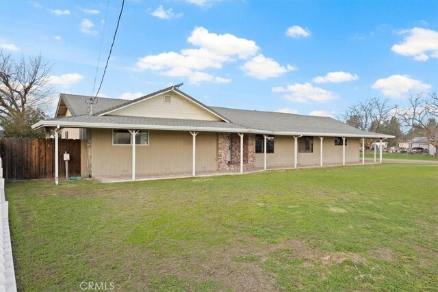 rear view of property with a lawn