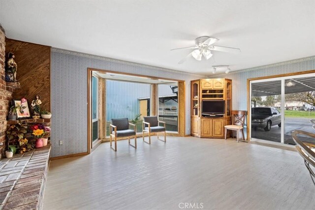 living room with ceiling fan and light hardwood / wood-style floors