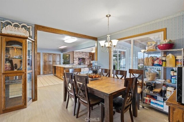 dining area with a notable chandelier and light hardwood / wood-style flooring