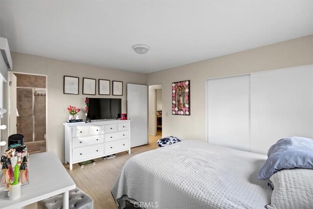 bedroom featuring light wood-type flooring and a closet