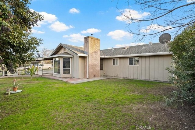 back of house featuring a yard and a patio