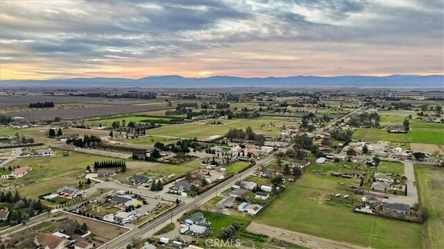 aerial view at dusk featuring a mountain view