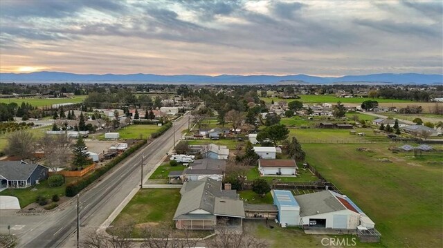 aerial view at dusk featuring a mountain view