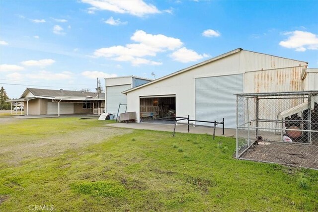 exterior space featuring an outbuilding and a lawn