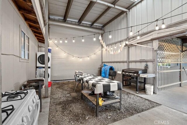 view of patio with stacked washing maching and dryer and grilling area