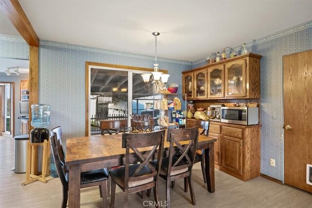 dining area with a notable chandelier and light wood-type flooring