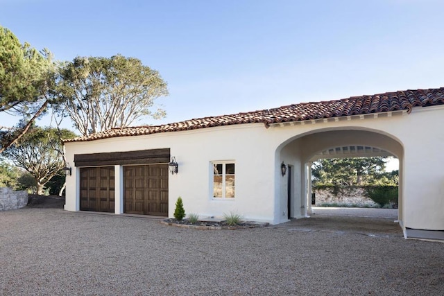 mediterranean / spanish house with a garage