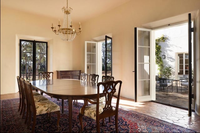 dining room with french doors and a notable chandelier