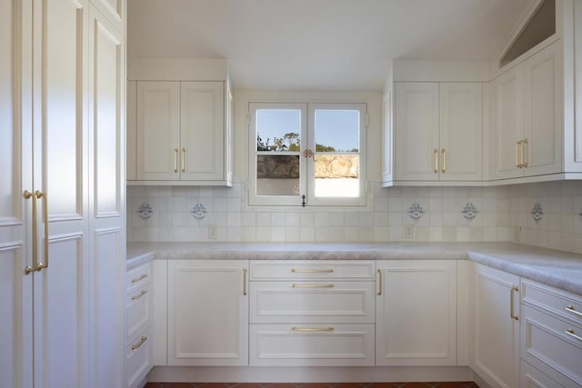 kitchen with white cabinets and tasteful backsplash